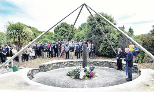 ?? PHOTO: PETER MCINTOSH ?? Mark of respect . . . Police chaplain Monsignor John Harrison leads a prayer for the victims of the Aramoana massacre during a service to mark the 30th anniversar­y of the shootings on Saturday.