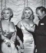  ?? ?? ‘STORM IN A B-CUP’: Sisters Marion and Valerie Mitchell in topless dresses, with an admirer