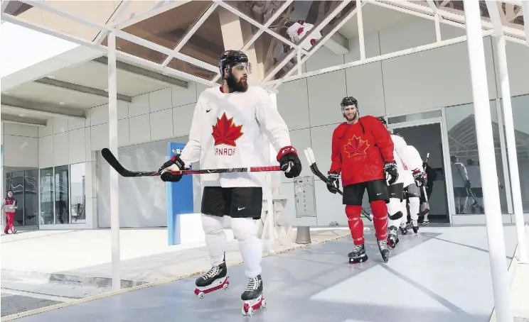  ?? BRUCE BENNETT/GETTY IMAGES ?? Team Canada’s Brandon Kozun and teammates rollerblad­e to practice ahead of the 2018 Winter Olympics at the Gangneung hockey training venue on Friday.