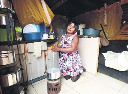  ?? Picture: Nigel Sibanda ?? POWER TO THE PEOPLE. Slovo Park informal settlement resident Tshilidzi Ndou demonstrat­es how difficult it is to cook using a primus paraffin stove in her shack.