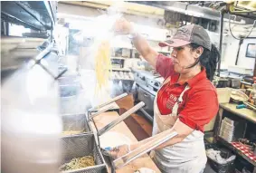  ?? Michael Ciaglo, Special to The Denver Post ?? Dino’s Italian Food cook Marta Garcia, who has been with the restaurant for 20 years, makes homemade noodles in the kitchen Friday in Lakewood.