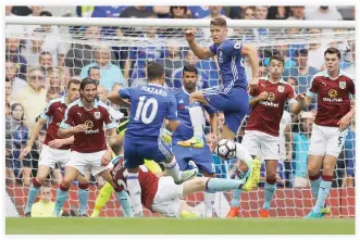  ??  ?? TENSE MOMENT: Chelsea’s Gary Cahill, center, jumps over the ball during the English Premier League soccer match against Burnley at Stamford Bridge in London, Saturday. (AP)
