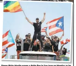  ??  ?? Singer Ricky Martin waves a Pride flag in San Juan on Monday as he joins with thousands of other people (above) calling for Gov. Ricardo Rossello (above inset) to leave office.