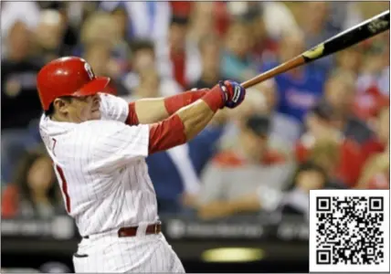  ?? AP Photo ?? Carlos Ruiz of the Phillies follows through after hitting a three-run home run off Washington Nationals starting pitcher Ross Detwiler in the third inning Tuesday. Scan the code for full coverage.