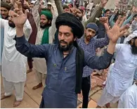  ?? AFP ?? supporters of tehreek-e-labbaik Pakistan (TLP) chant slogans as they block a street during a protest in Lahore on Friday. —