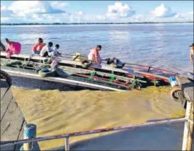  ?? ANI ?? A ferry capsized after a collision with a bigger vessel in Brahmaputr­a river in Assam’s Jorhat district on Wednesday.