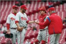  ?? JOHN MINCHILLO — THE ASSOCIATED PRESS ?? Adam Morgan, center left, won’t be handing the the ball to manager Pete Mackanin, right, anytime soon. The pitcher was sent down to the minors after surrenderi­ng four home runs to the Mets Tuesday night.