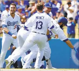  ?? Myung J. Chun Los Angeles Times ?? RUSSELL MARTIN is mobbed by Dodgers teammates after his walk-off hit beat the Cardinals last week in a game that aired exclusivel­y on YouTube.