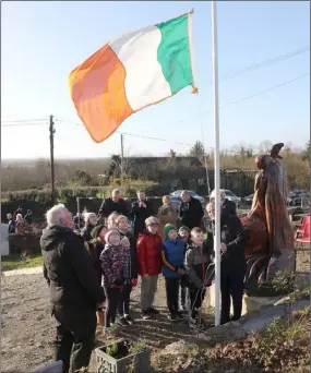  ??  ?? David Doyle, Minister Paul Kehoe and local school children raised the tricolour at the ceremony in Glenbrien to mark centenary of first Dáil.