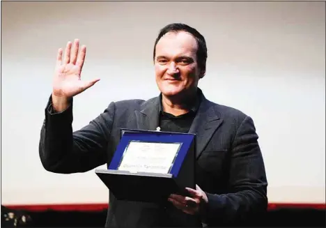  ?? ?? Director Quentin Tarantino waves to spectators after receiving the Lifetime Achievemen­t Award at the 16th edition of the Rome Film Fest in Rome, Tuesday, Oct. 19. (AP)