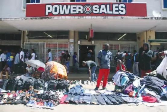  ??  ?? File pic: Informal traders sell their wares right in front of a clothing retail shop.