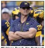  ?? (AP/Paul Sancya) ?? Michigan Coach Jim Harbaugh watches Saturday before the team’s game against Rutgers in Ann Arbor, Mich. The Wolverines won 31-7 in Harbaugh’s first game back since being suspended by the school for the first three games of the season.