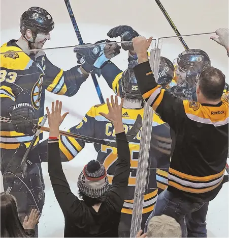  ?? STAFF PHOTO BY MATT STONE ?? PARTY TIME: The crowd erupts as the Bruins celebrate Brad Marchand’s game-winning goal last night at the Garden.