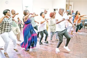  ??  ?? The Soweto Gospel Choir perform during a rehearsal at the Scout’s Hall in Rosebank, Johannesbu­rg on Feb 21. Soweto Gospel Choir’s ‘Freedom’ album, which celebrates the life of Nelson Mandela, is the Grammy winner of the best World music album category, the South African ensemble solidified its place in the music history books. When the Soweto Gospel Choir was named as winner of the Grammy for Best World Music Album, it earned the ensemble a place in the music history books. (Above left) Duduzile Ngomane and Surprise Sidumo, members of The Soweto Gospel Choir, sing during the rehearsal. — AFP photos