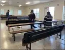  ??  ?? Volunteers place tables to be used for dining indoors at the new Beamer Street shelter on East Beamer Street.