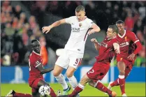  ?? Picture: GETTY IMAGES ?? CENTRE OF ATTRACTION: Edin Dzeko of AS Roma battles with Sadio Mane, left, and James Milner of Liverpool