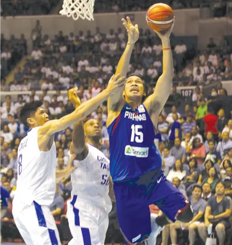  ?? PHILIPPINE STAR PHOTO SERVICE ?? Cebu's pride June Mar Fajardo of Gilas Pilipinas shoots over Chinese-Taipei defenders during their FIBA World Cup qualifier last night at the Smart Araneta Coliseum. Gilas won, 90-83, to go 2-0.