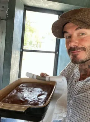  ??  ?? BAKERS OR FAKERS: Amanda Holden chopping onions in swimming goggles and David Beckham with his homemade brownies