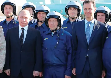  ?? AP ?? Vladimir Putin and Syrian president Bashar Assad at the Hmeimim base where Mr Putin announced a partial pullout of Russian forces from Syria