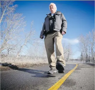  ?? LEAH HENNEL/ CALGARY HERALD ?? David Peyto, at Glenmore Reservoir pathway on Tuesday, is on a mission to walk every street in Calgary and is documentin­g his progress on Flickr.