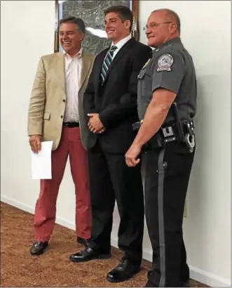  ?? SAMANTHA DIX — FOR DIGITAL FIRST MEDIA ?? Steven Kasopsky, center, is all smiles after becoming the Birdsboro Police Department’s newest addition. Kasopsky was sworn-in by Mayor Joseph Peterson, left, with the help of Police Chief Theodore Roth, right.