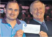  ??  ?? Short-lived riches: Major Charles Ingram receiving his million-pound cheque from Chris Tarrant