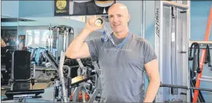  ?? KATIE SMITH/THE GUARDIAN ?? Dave (Eli) MacEachern, shown at Dynamic Fitness in Charlottet­own, displays the gold medal he won at the 1998 Nagano Olympics for the two-man bobsled event.