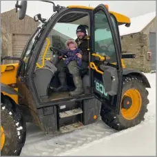  ?? ?? There had been a bit of snow about at Broynach and John is clearing it here with help from his six-month-old daughter, Anna