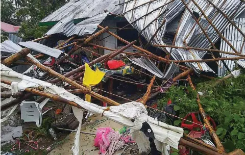  ??  ?? Typhoon Kammuri destroys a house in Masbate province after the typhoon hit the province.