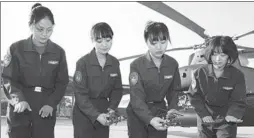  ?? CHEN KAI/ FOR CHINA DAILY ?? Four of the People’s Liberation Army’s first five female combat helicopter pilots review maneuvers during training in October 2014.