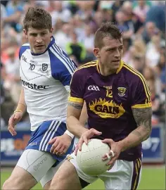  ??  ?? Adrian Flynn gets away from Darren Hughes of Monaghan.