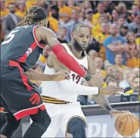  ?? AP PHOTO ?? Cleveland Cavaliers’ LeBron James (right) drives past Toronto Raptors’ DeMarre Carroll in the first half of Game 1 of a second-round NBA playoff series Monday in Cleveland.