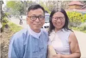  ?? AP PHOTO ?? Hkalam Samson, left, smiles for a photo Wednesday with his wife after his initial release from prison in Myintkyina township in Kachin state, Myanmar.