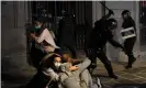  ??  ?? Riot police in Barcelona use batons to disperse protests against Covid restrictio­ns. Photograph: AFP/Getty Images