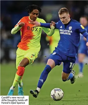  ?? ?? Cardiff’s new recruit Alfie Doughty holds off Forest’s Djed Spence