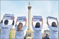  ?? AP PHOTO ?? People gesture as they attend a vigil in Trafalgar Square, London, Tuesday for the victims of the attack which killed over 20 people as fans left a pop concert by Ariana Grande in Manchester on Monday night.