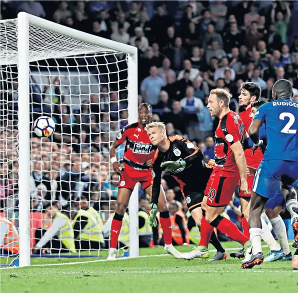  ??  ?? Miracle save: Chelsea are denied by the outstandin­g Jonas Lossl, while Antonio Conte (right) is left to rue lost points