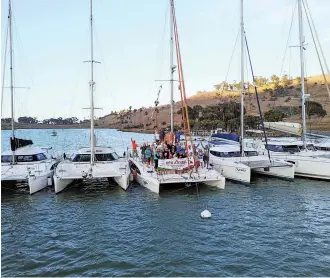  ??  ?? West Coast Multihulls hosts an annual fun rally to Catalina Island (above). Mark Gonsalves, owner of Cruise Abaco, smiles with customers (right). A Jeanneau from Desolation Sound Yacht Charters rests in a picturesqu­e anchorage.