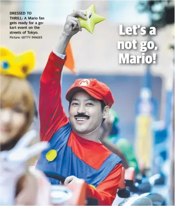  ?? Picture: GETTY IMAGES ?? DRESSED TO THRILL: A Mario fan gets ready for a gokart event on the streets of Tokyo.