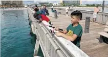  ?? FILE PHOTO ?? Joey Adorno fishes off the Deerfield Beach Internatio­nal Fishing Pier during a fishing lesson for kids. The city is gearing up to host its annual Jr. Anglers Day on Sept. 16.