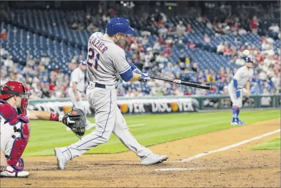  ?? Photos by Mitchell Leff / Getty Images ?? Todd Frazier of the Mets hits a three-run homer as part of a five-run ninth-inning against the Phillies at Citizens Bank Park on Friday in Philadelph­ia.