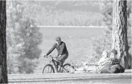  ?? RICH PEDRONCELL­I/AP 2017 ?? About 67% of Lake Tahoe’s households make less money than needed for housing and living expenses. Above, a bicyclist in South Lake Tahoe, California.