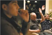  ?? Mason Trinca / Special to The Chronicle ?? Bryant Acosta, Stan Zervas and Chuck Coleman vote during the Benicia-Vallejo Food Co-op meeting.