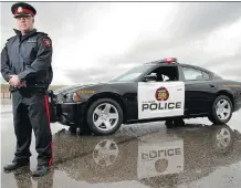  ?? FILES ?? Inspector Ken Thrower stands near a black and white car in 2012. That’s when the Crown Victorias city police had used were discontinu­ed.