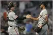  ?? ABBIE PARR — THE ASSOCIATED PRESS ?? San Francisco Giants catcher Patrick Bailey, left, and relief pitcher Camilo Doval shake hands after a 4-3win against the Minnesota Twins on Tuesday in Minneapoli­s.