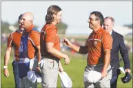  ?? Alastair Grant / Associated Press ?? Europe’s Francesco Molinari, right, and Tommy Fleetwood celebrate after winning a foursome match on the second day of the Ryder Cup at Le Golf National in Saint-Quentin-en-Yvelines, France, on Saturday.