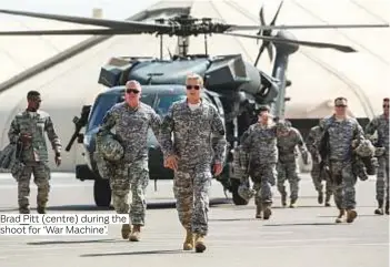  ?? Photos courtesy of twofour54, Diff365@VOX and The Doha Film Institute ?? Brad Pitt (centre) during the shoot for ‘War Machine’.