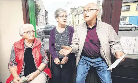  ??  ?? Heart of the matter: Loretto McDermott, Pam Kiernan and Chris Kirk chat in Killeshand­ra post office; right, butcher Nudie McGovern fears for his business Photos: Steve Humphreys