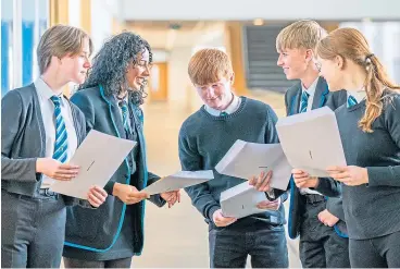  ?? Picture Jane Barlow ?? Pupils at Auchmuty High School in Glenrothes, Fife, check their exam results on Tuesday