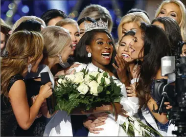  ?? NOAH K. MURRAY ?? FILE - This Sept. 9, 2018 file photo shows Miss New York Nia Franklin, center, reacting after being named Miss America 2019 in Atlantic City, N.J. The Miss America Organizati­on says this year’s pageant will be held at the Mohegan Sun Connecticu­t in Uncasville, Connecticu­t. It will be broadcast on NBC Dec. 19, in a switch from recent broadcaste­r ABC.